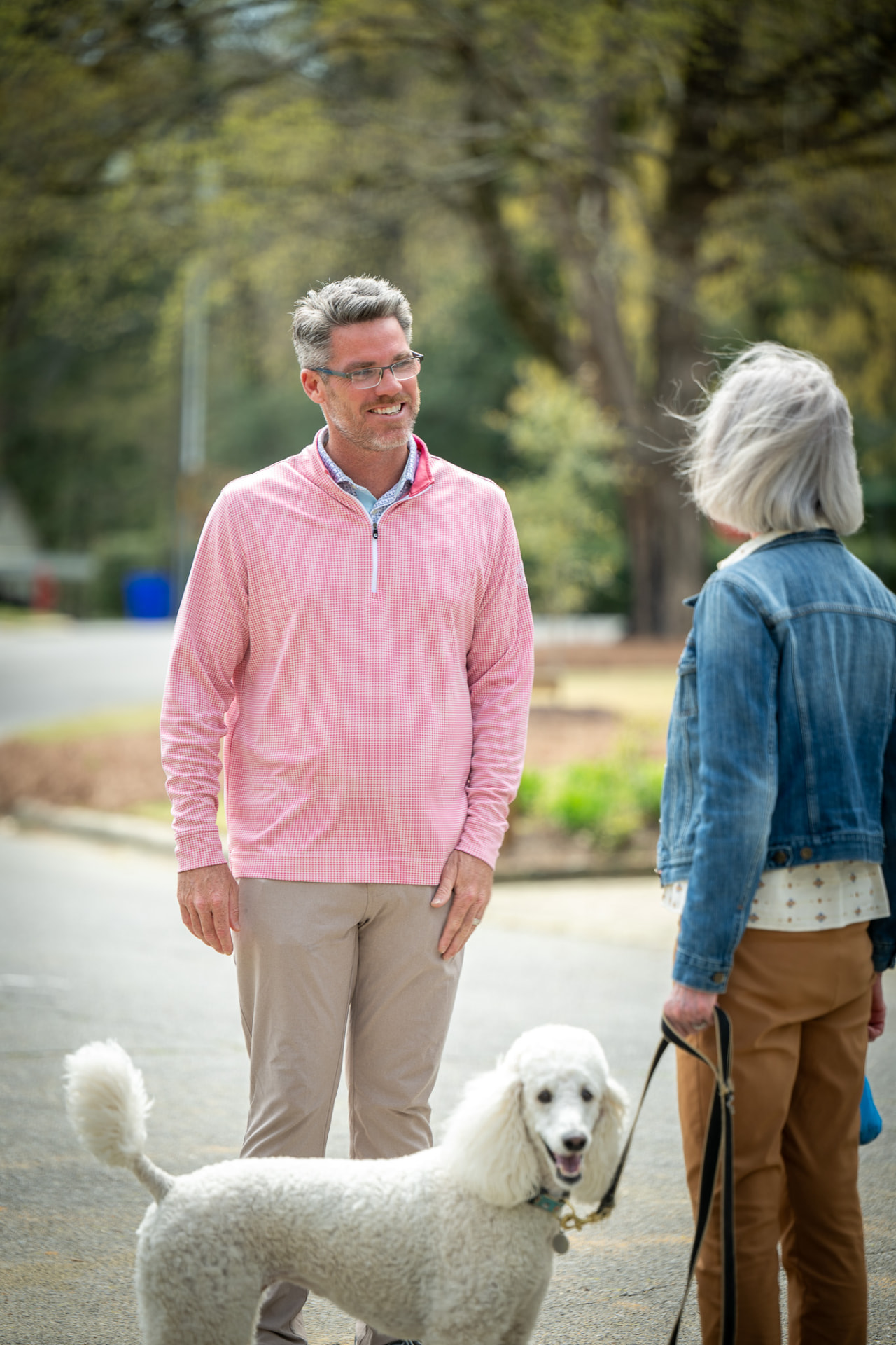 J. Tyler Williams speaking with a client outdoors on a residential street