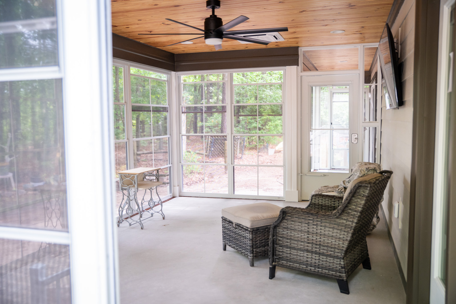 Screened Porch Addition — Screened porch with a stained pine ceiling, exposed beam, mini-split conditioning and a broom-finished slab.